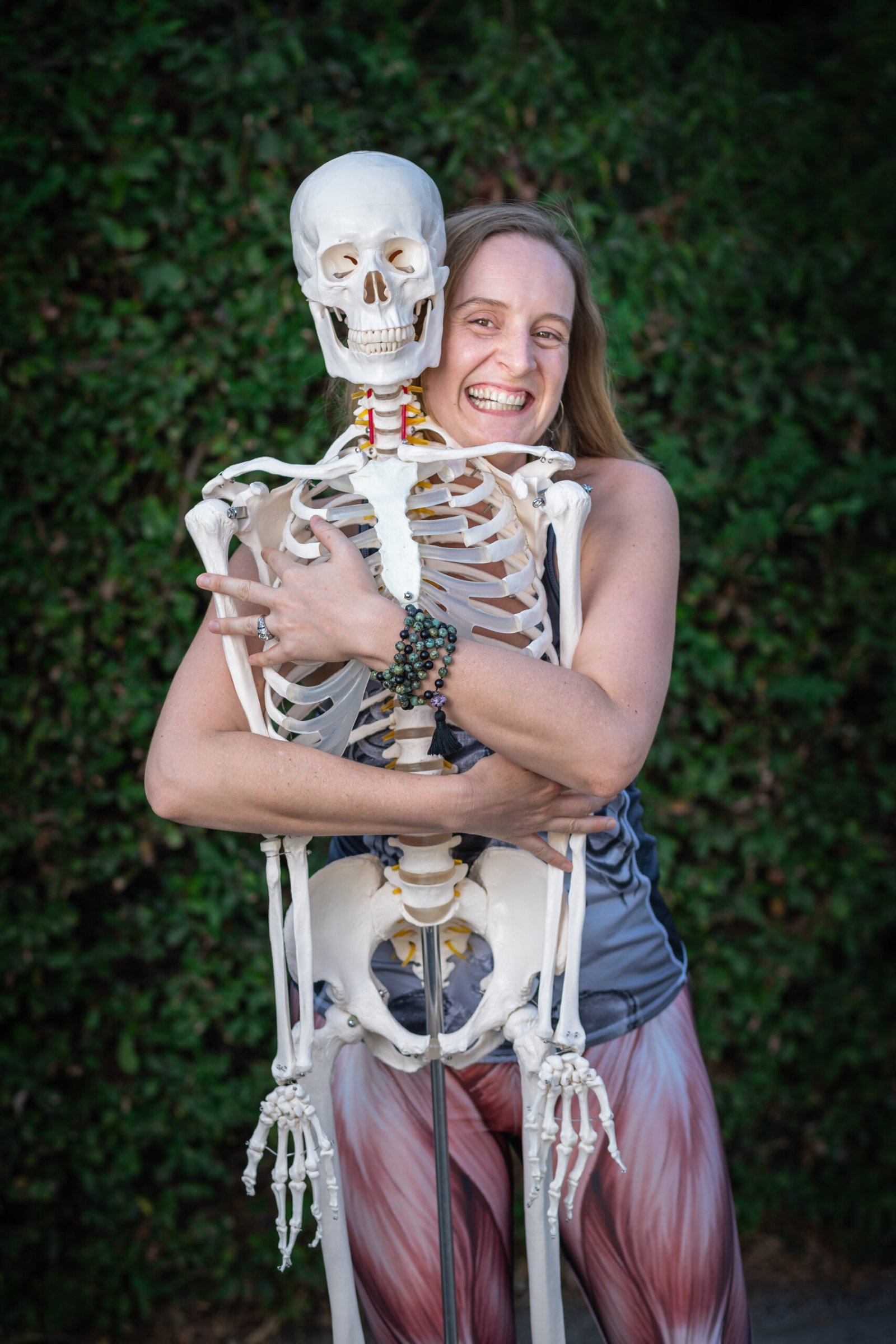 Charlotte hugging a model skeleton